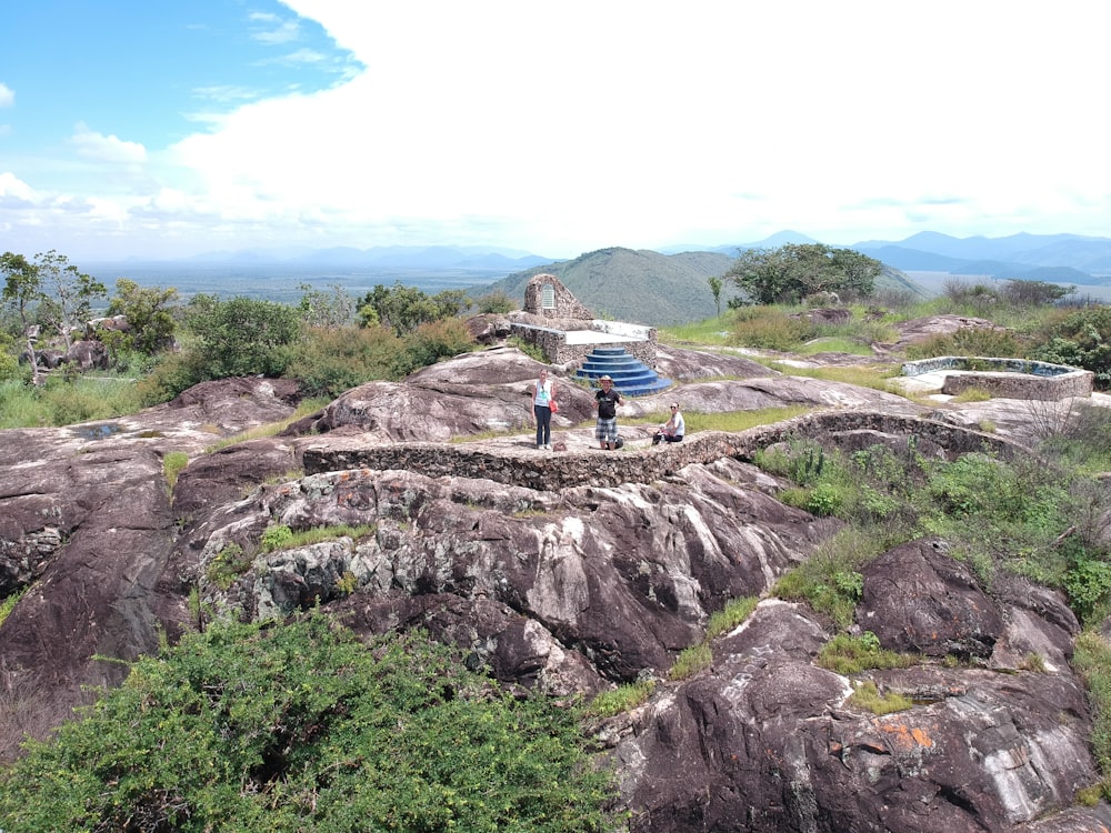 two person standing on cliff