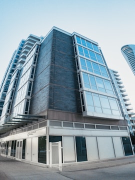 Modern commercial building in Houston with large windows and storefronts.