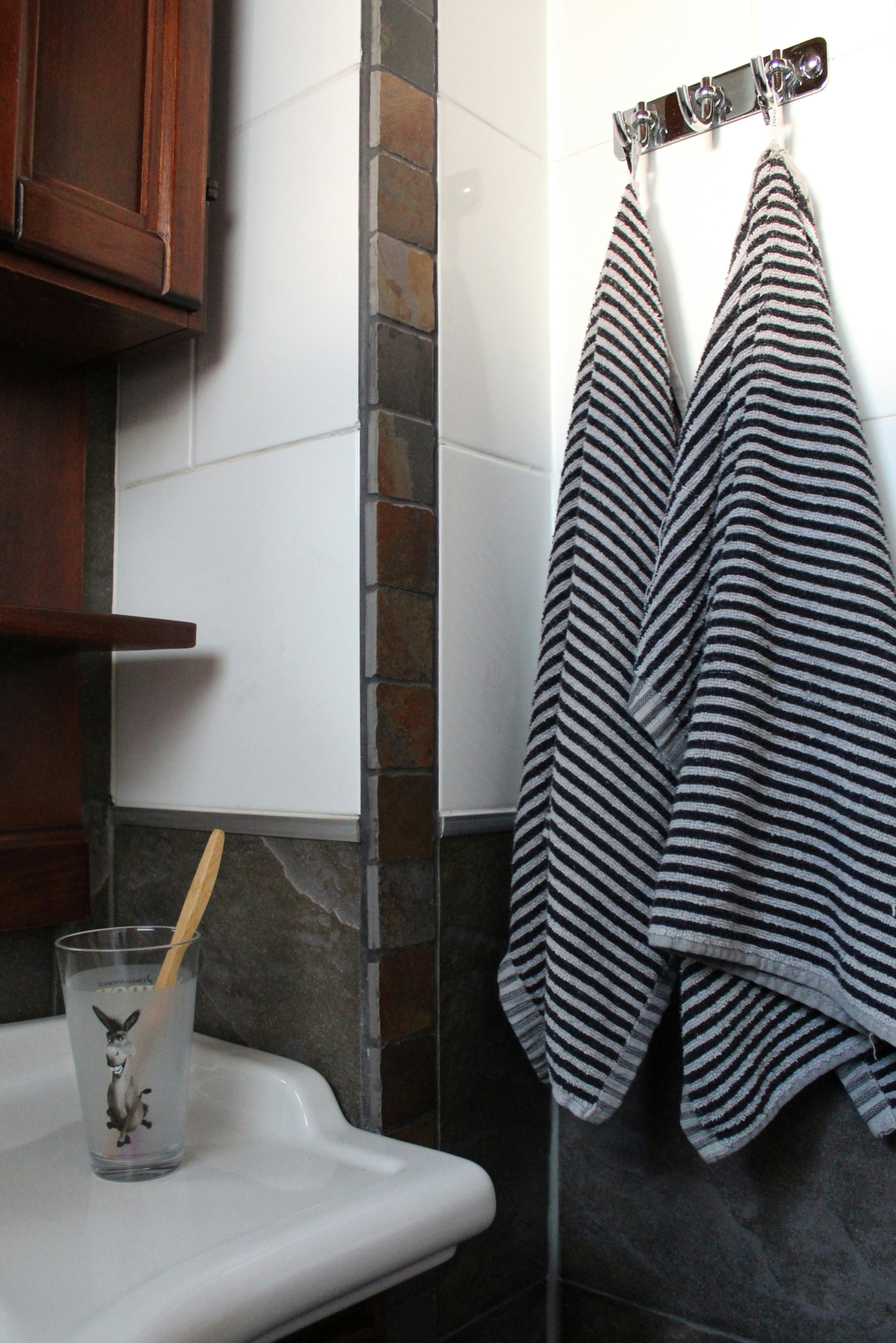 black and white towel beside wall