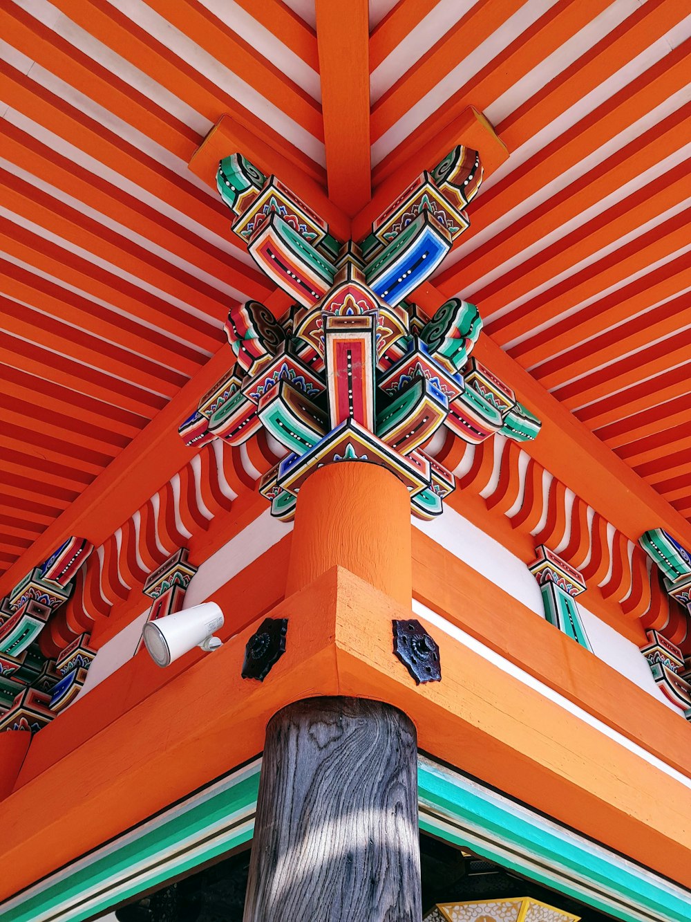 a close up of a roof with a wooden pole