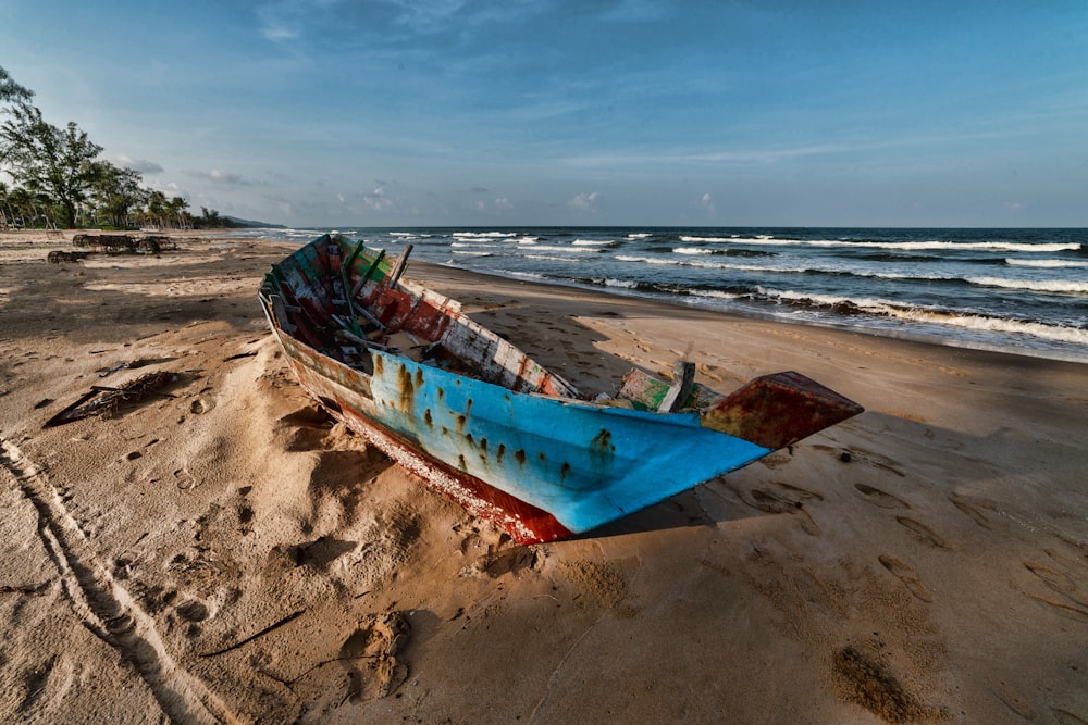 blue boat on seashore