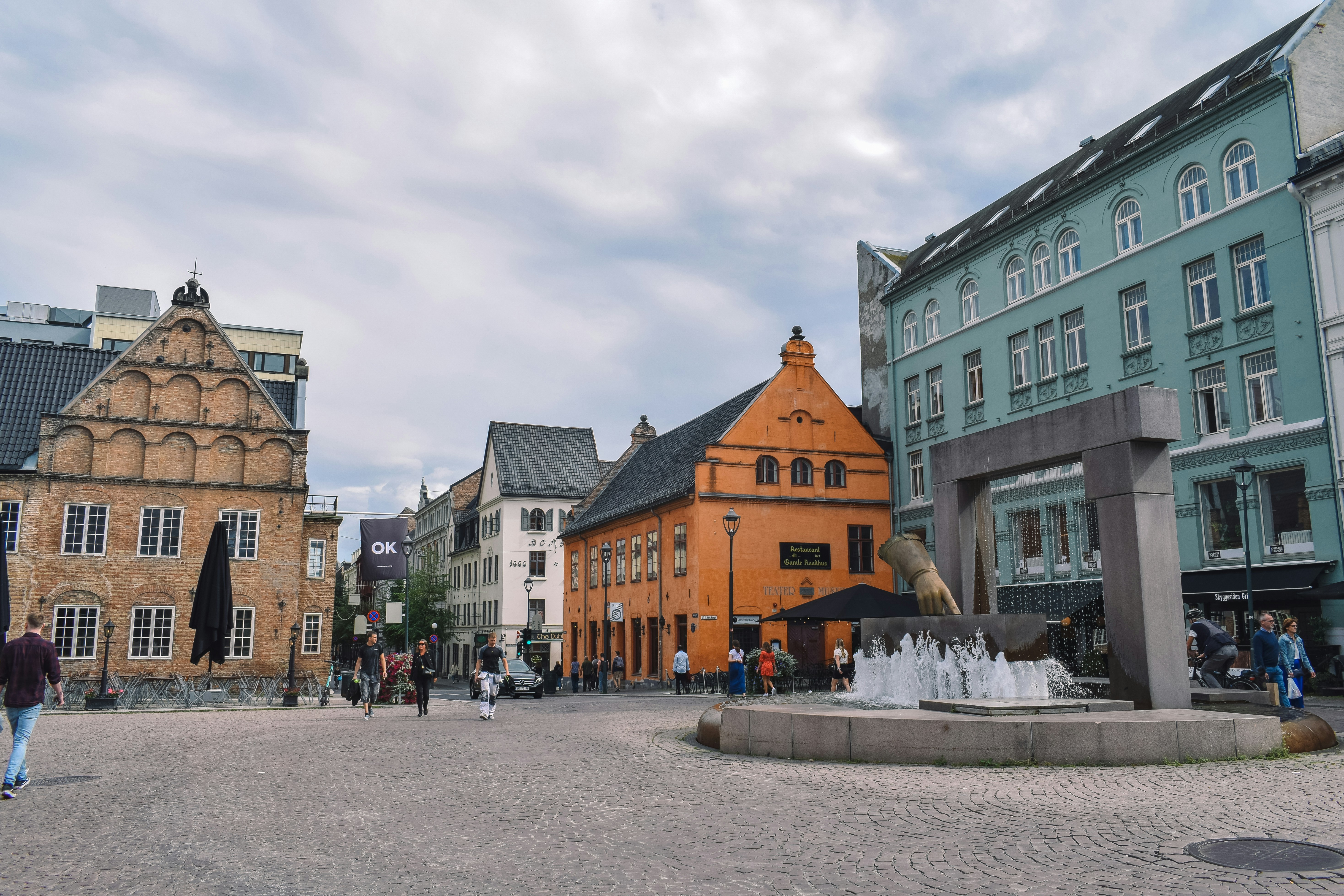 a group of people walking around a city square
