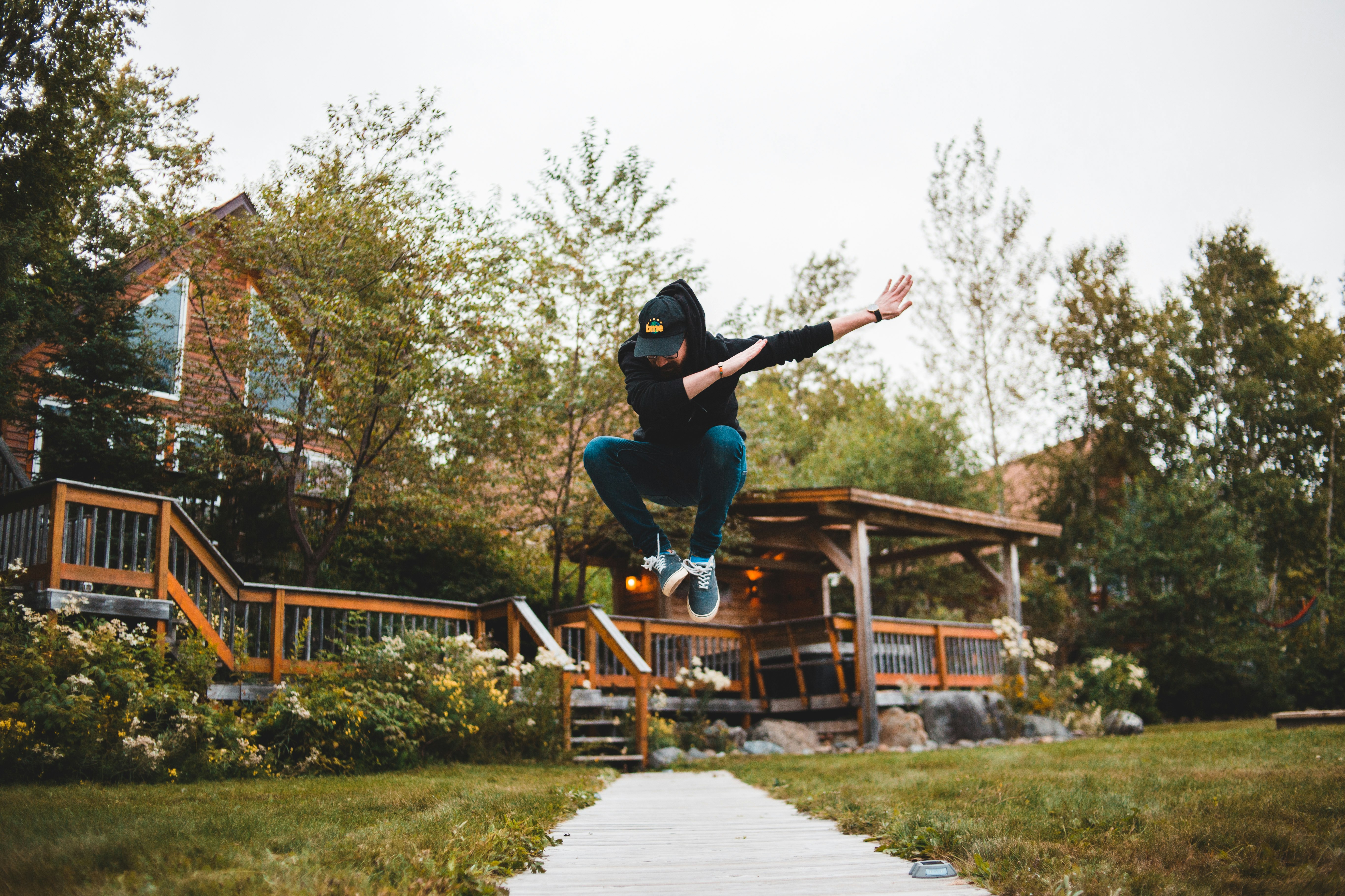 photography of man jumping near outdoor during daytime