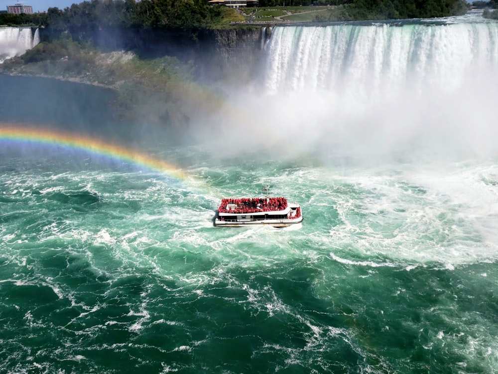 people on boat near falls