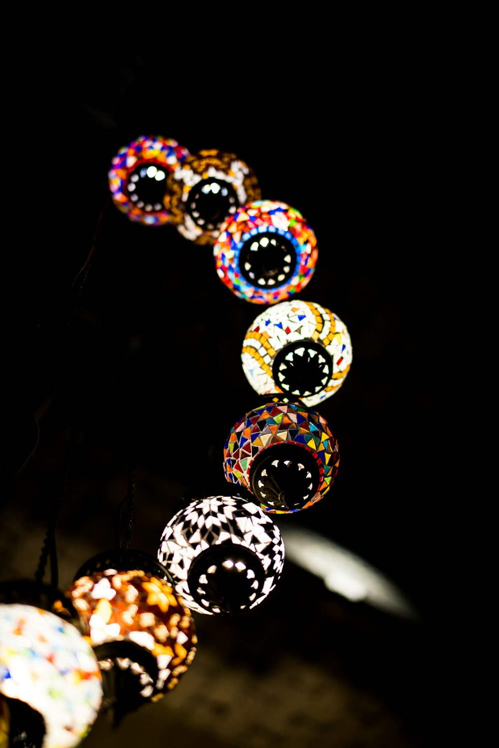 a string of colorful lights hanging from a ceiling