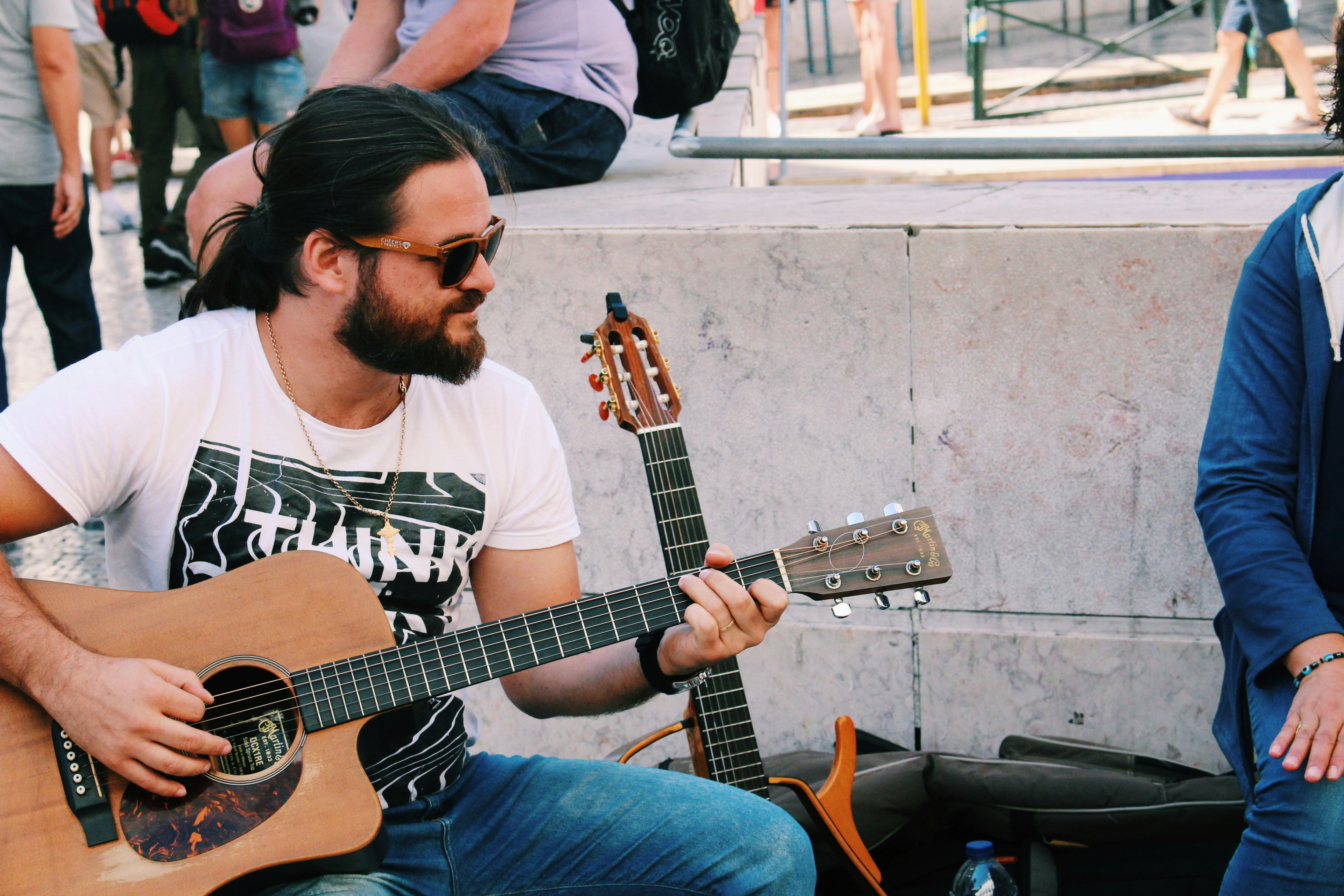 Man musician playing guitar on street