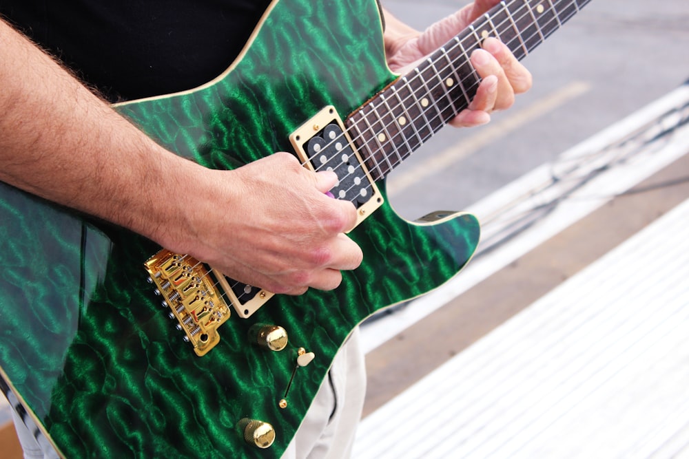 person playing electric guitar