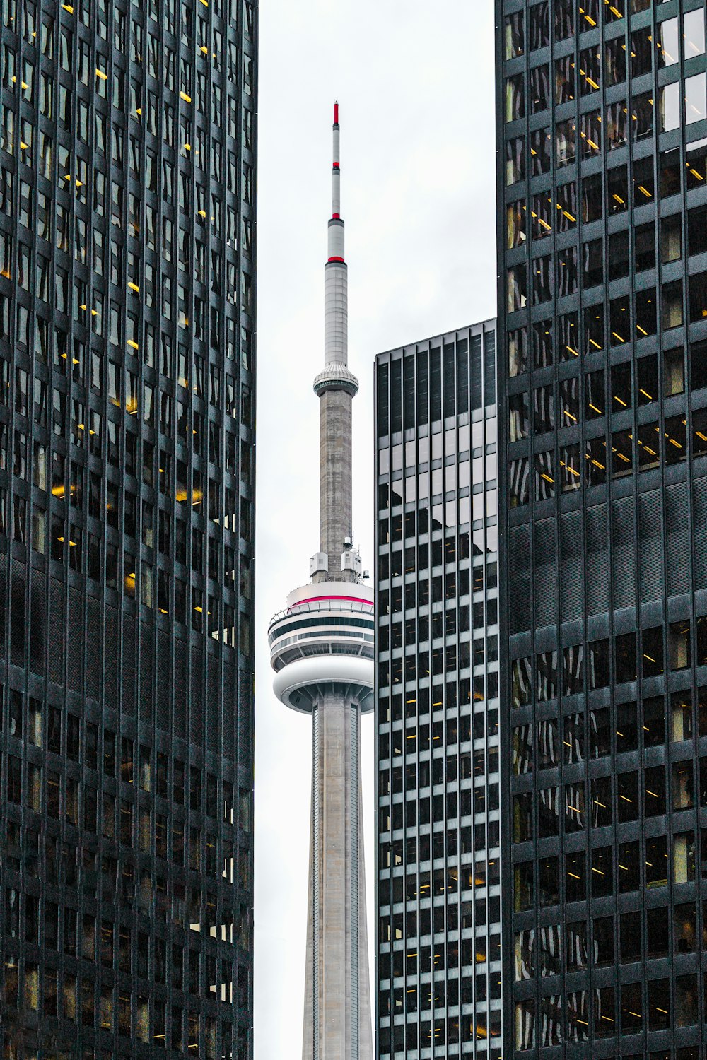 gray tower beside curtain wall high-rise buildings