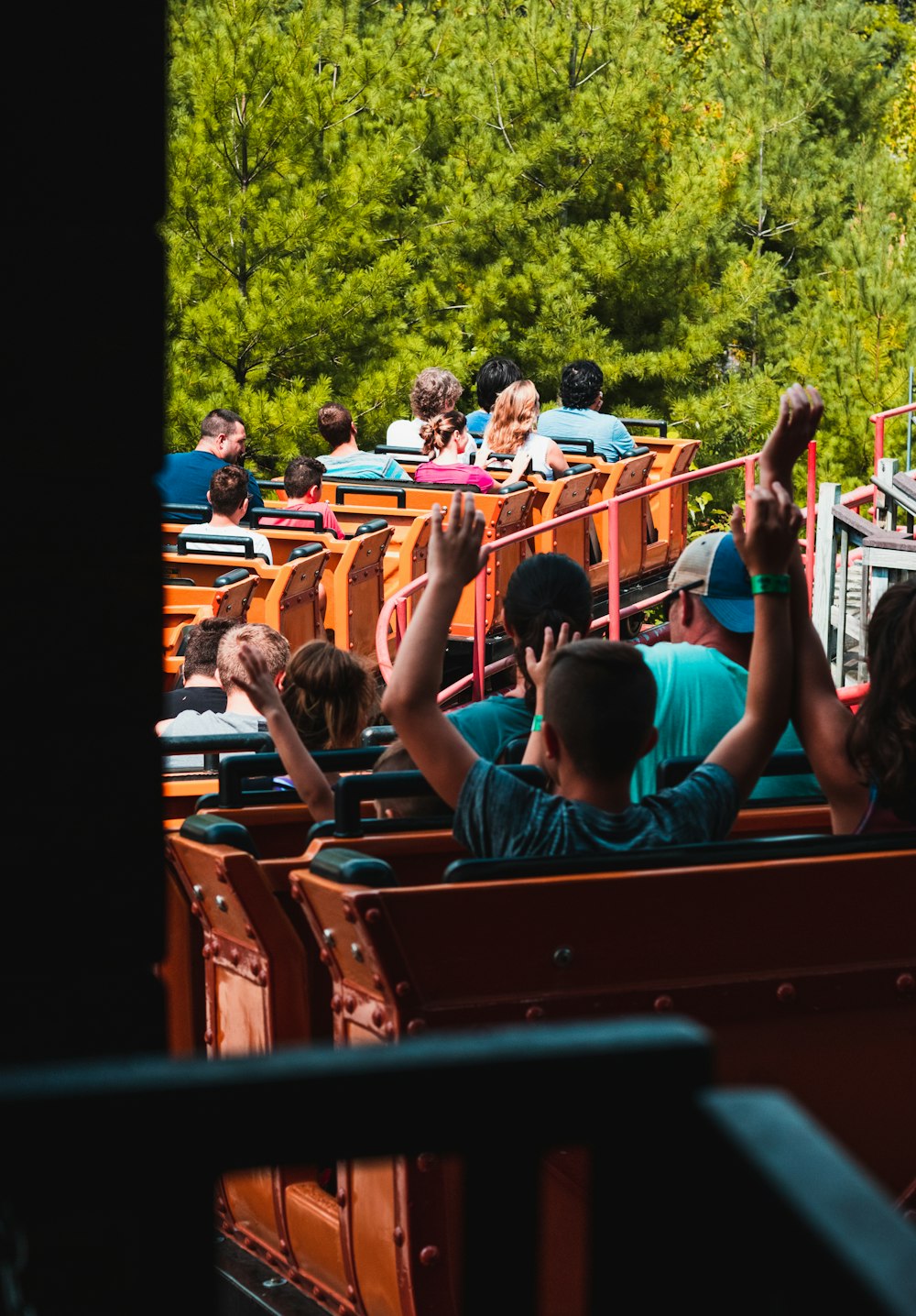 people riding on roller coaster