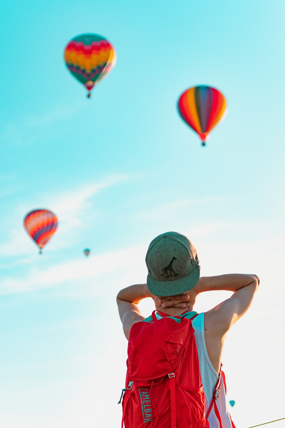 person looking at hot air balloons