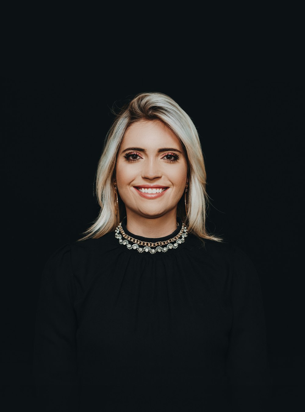 smiling woman wearing black crew-neck top