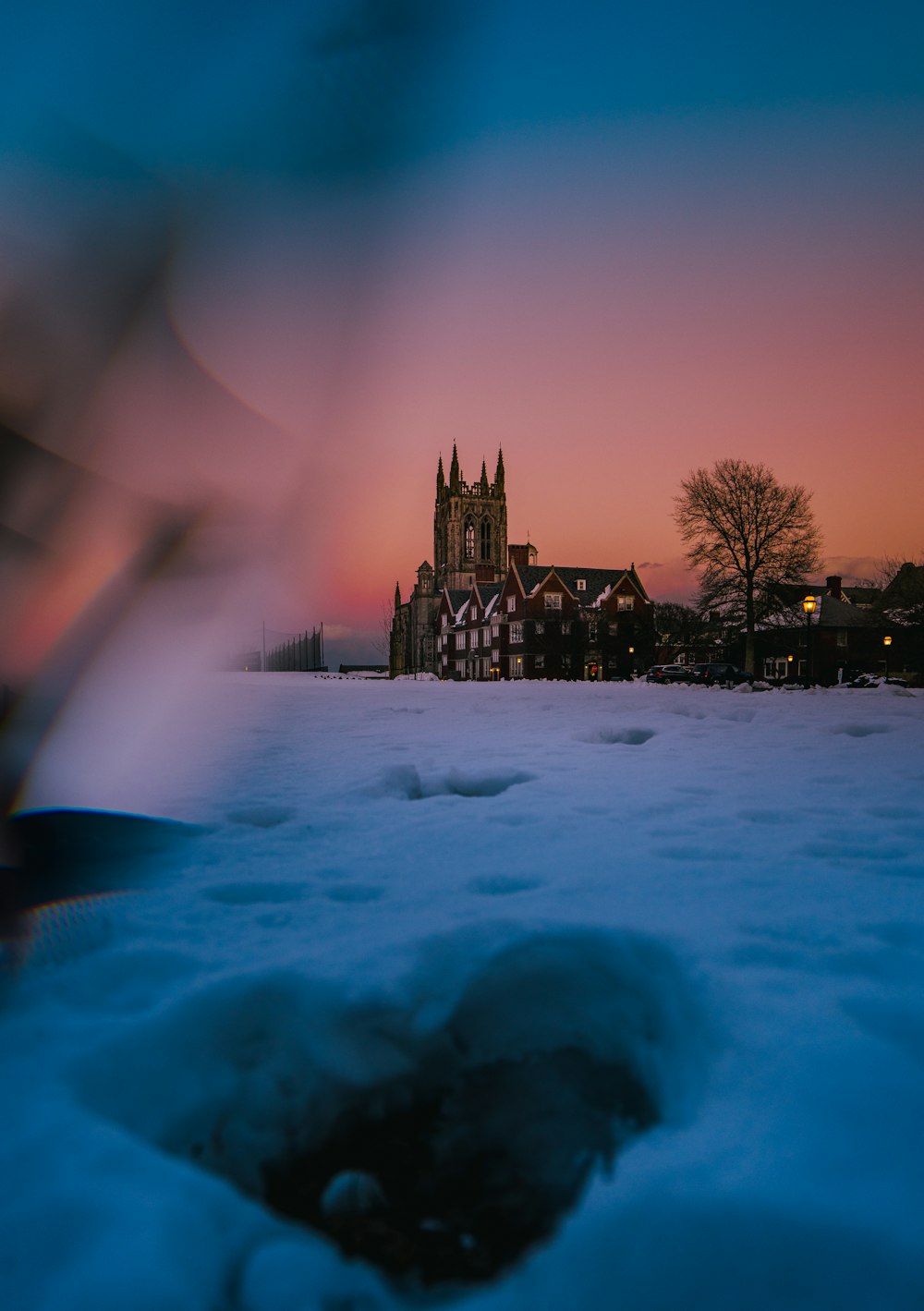 a view of a clock tower in the distance in the snow