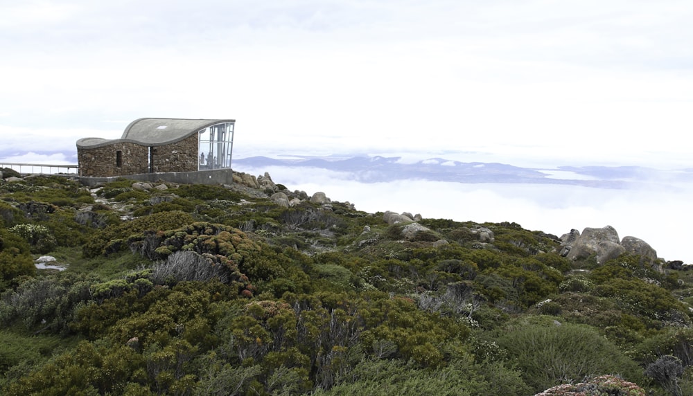 a building on top of a hill surrounded by trees