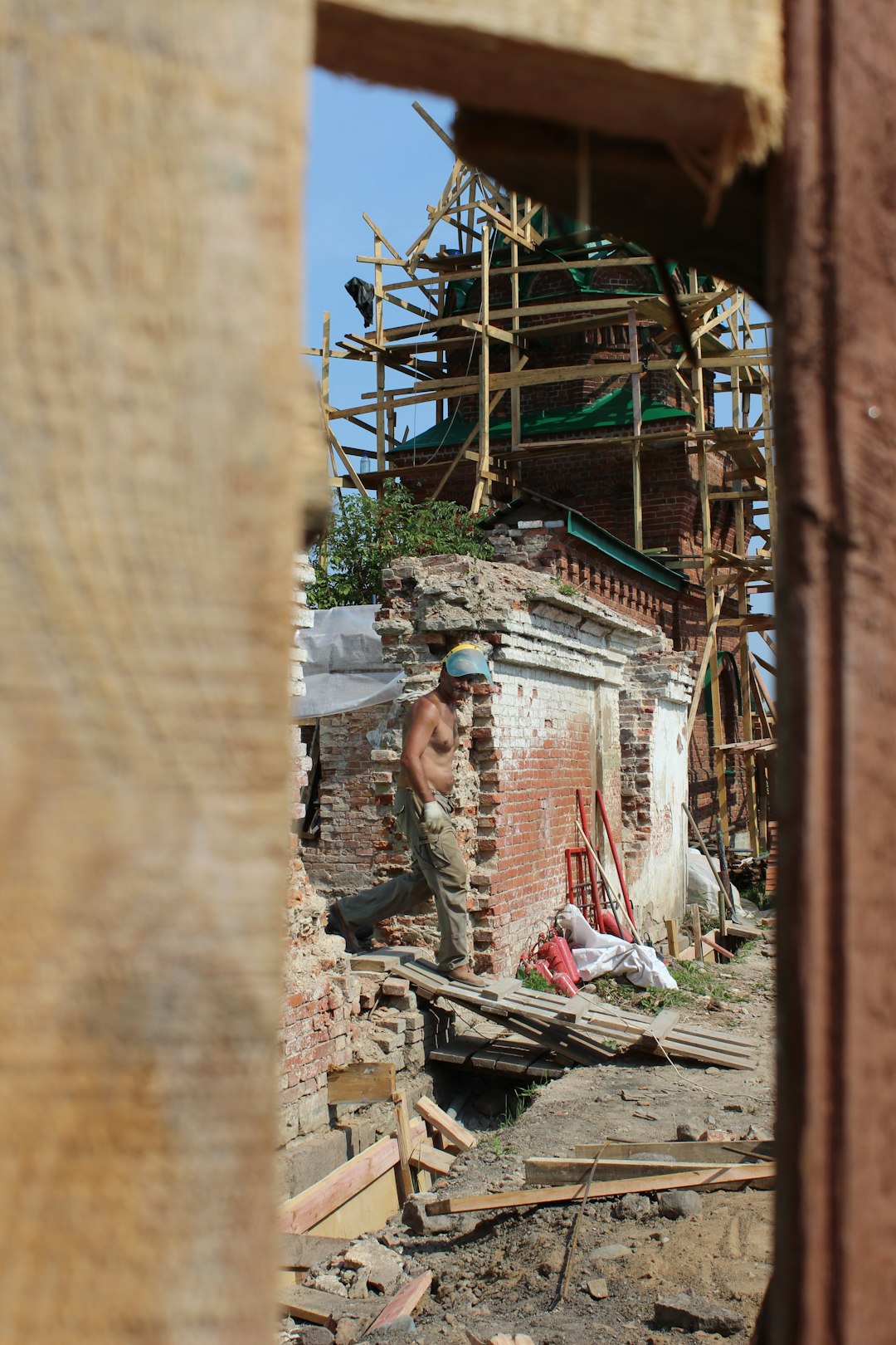 man walking on ramp beside wrecked building