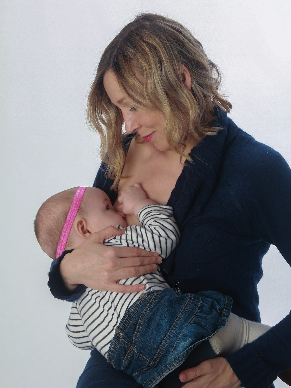 woman breast feeding baby