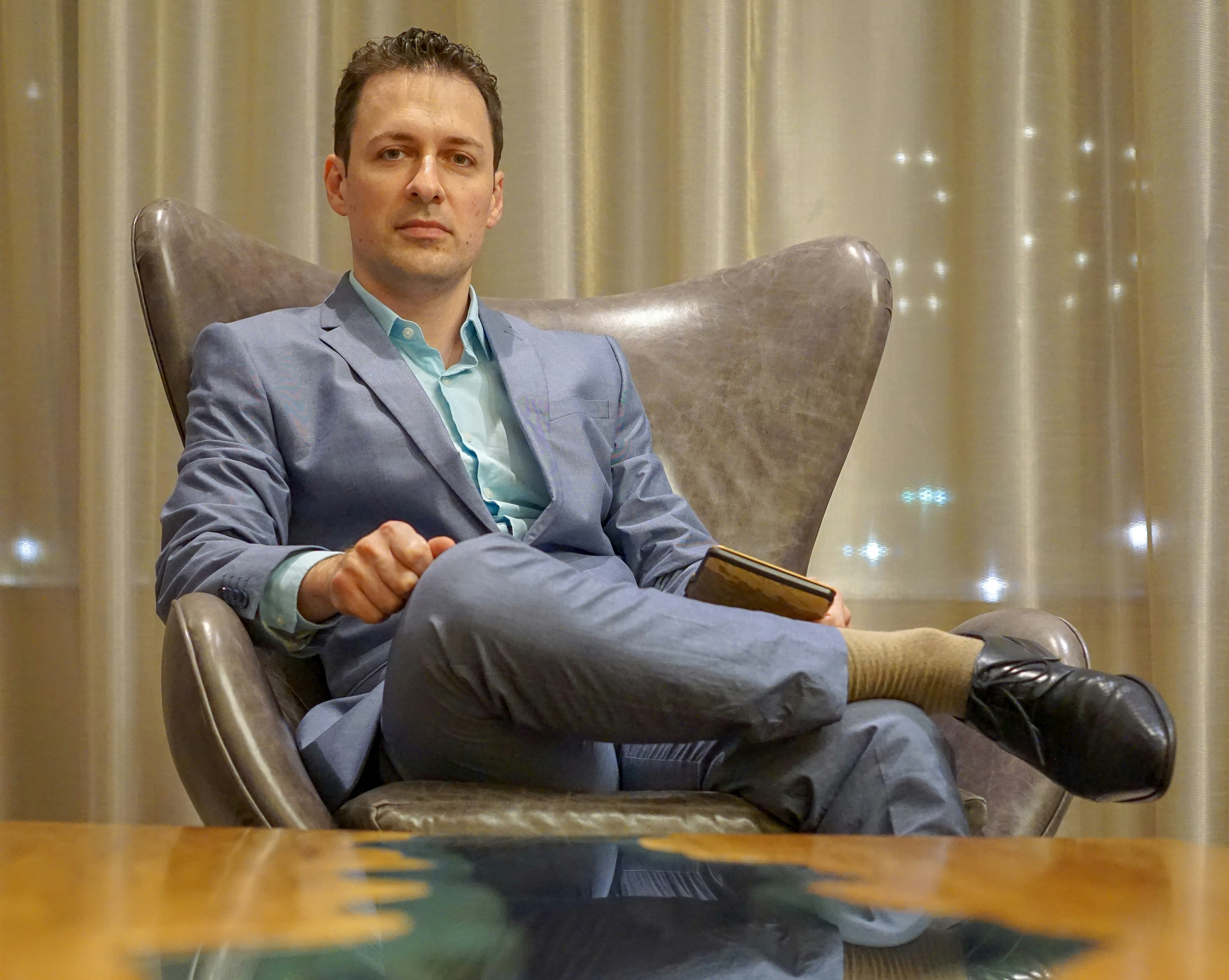 Man sitting in an executive chair (Photo by David Veksler on Unsplash)