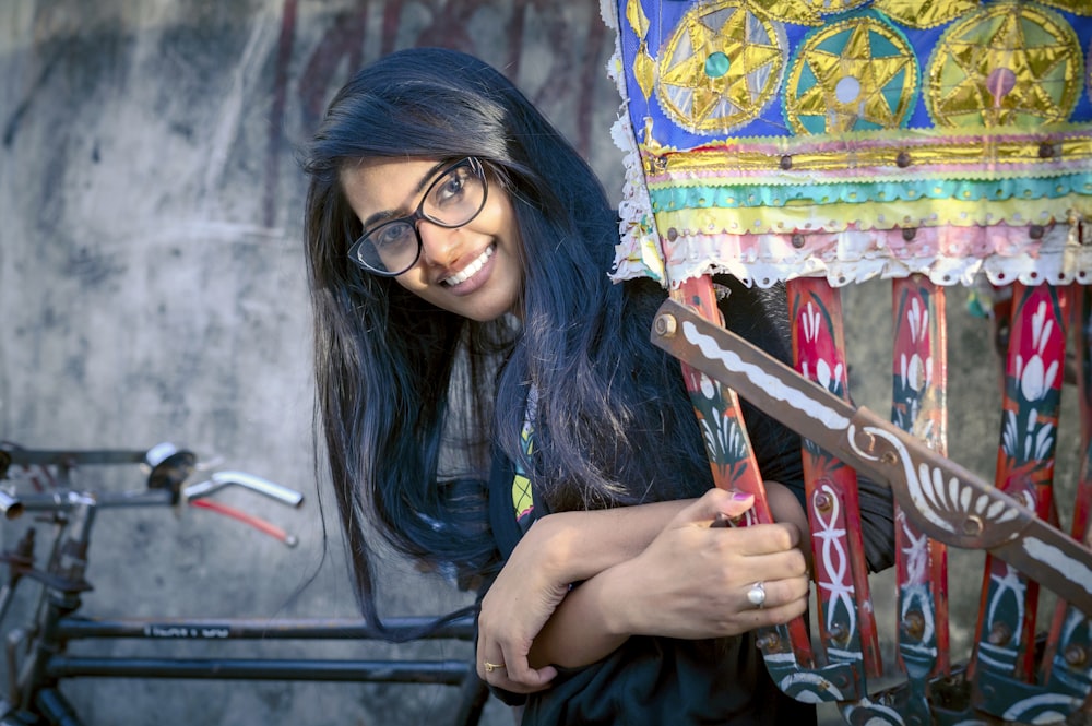 woman smiling in front of parked bike