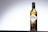 A bottle of Vana Tallinn is centered against a gradient background, transitioning from dark to light gray. The bottle has a textured cap and label detailing the brand and alcohol content, marked as 40. The design is classic with a focus on elegance and simplicity.
