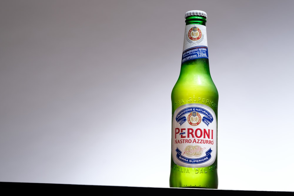 Peroni beverage bottle on black surface