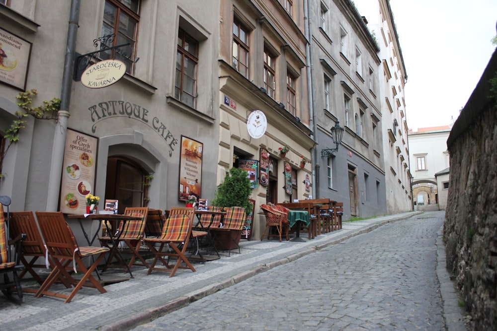 brown wooden chairs on sidewalk at daytime