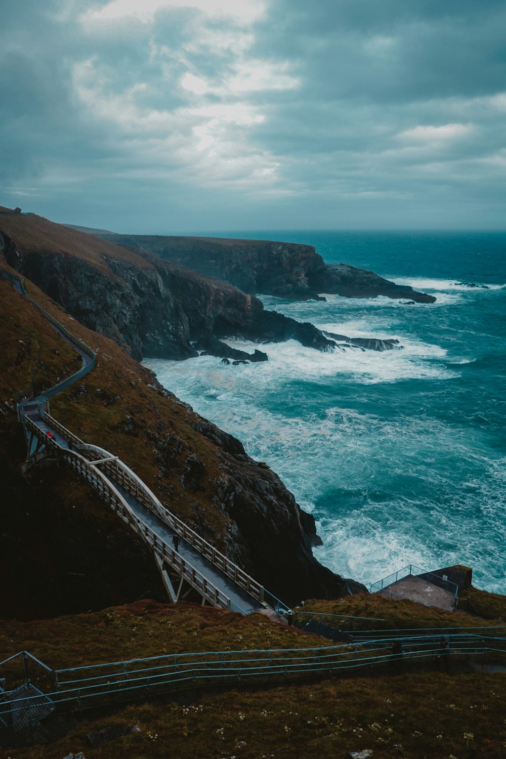 high-angle photography of bridge near blue beach