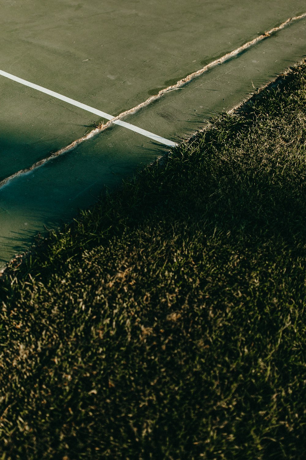 a tennis court with a tennis racket in the grass