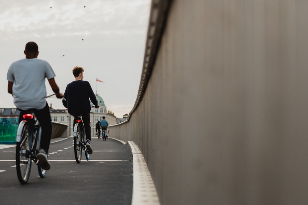 people biking on road during daytime