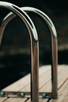 Satisfied clients shaking hands with the Metalcraft Pro team in front of a newly fabricated metal railing.