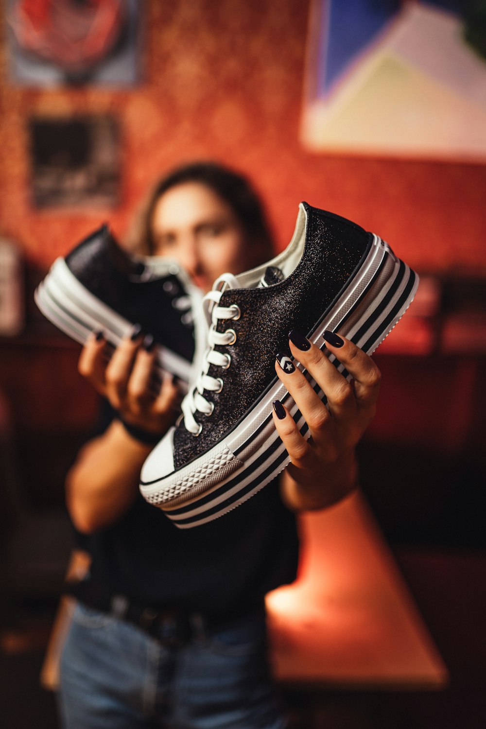 person showing black-and-white platform sneakers