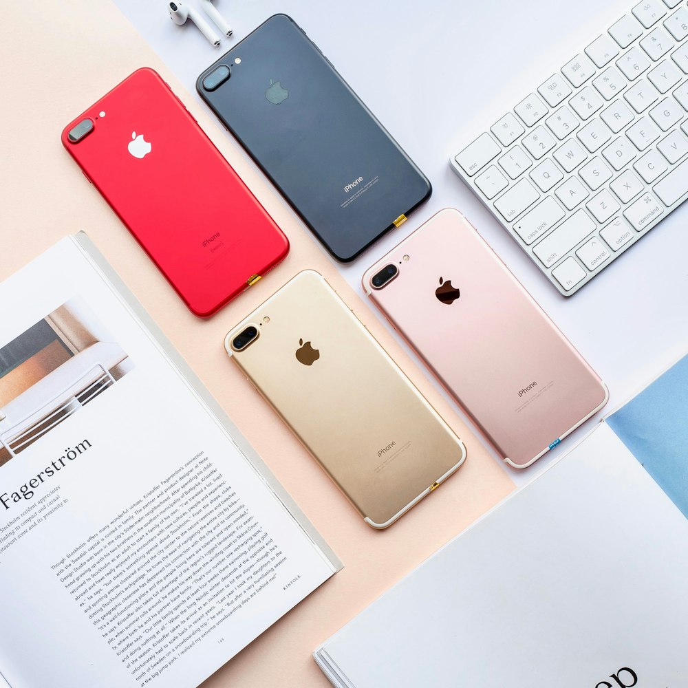 four assorted-color iPhone 7 Plus's on table