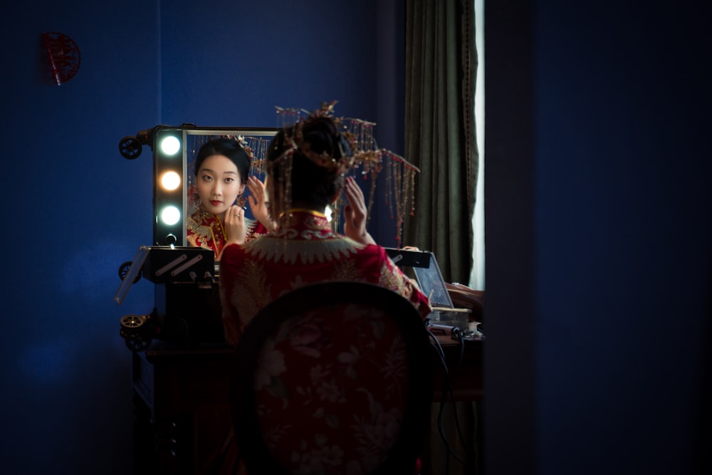 woman sitting in front of the mirror