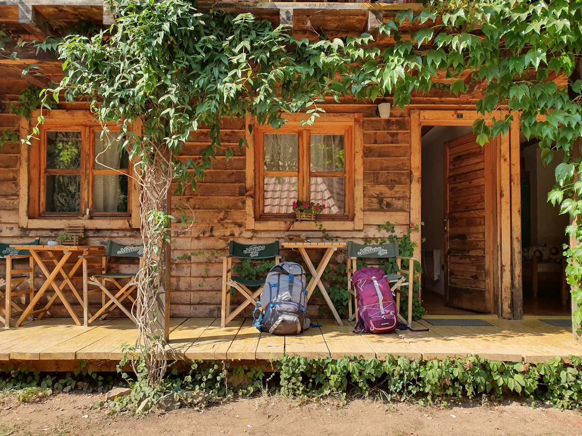 Two hiking backpacks near a door, ready for a scout camping trip, illustrating a scout packing list.