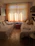 A cozy, sunlit twin-sharing room with modern furniture and warm decor.