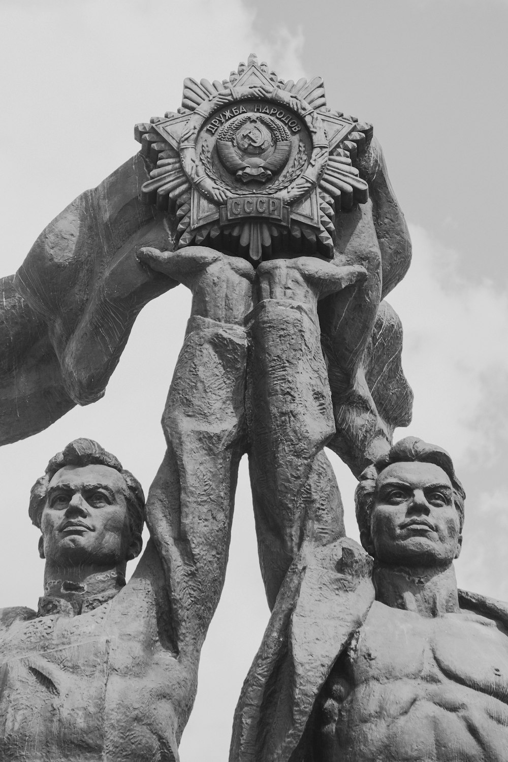 two men raising star statue