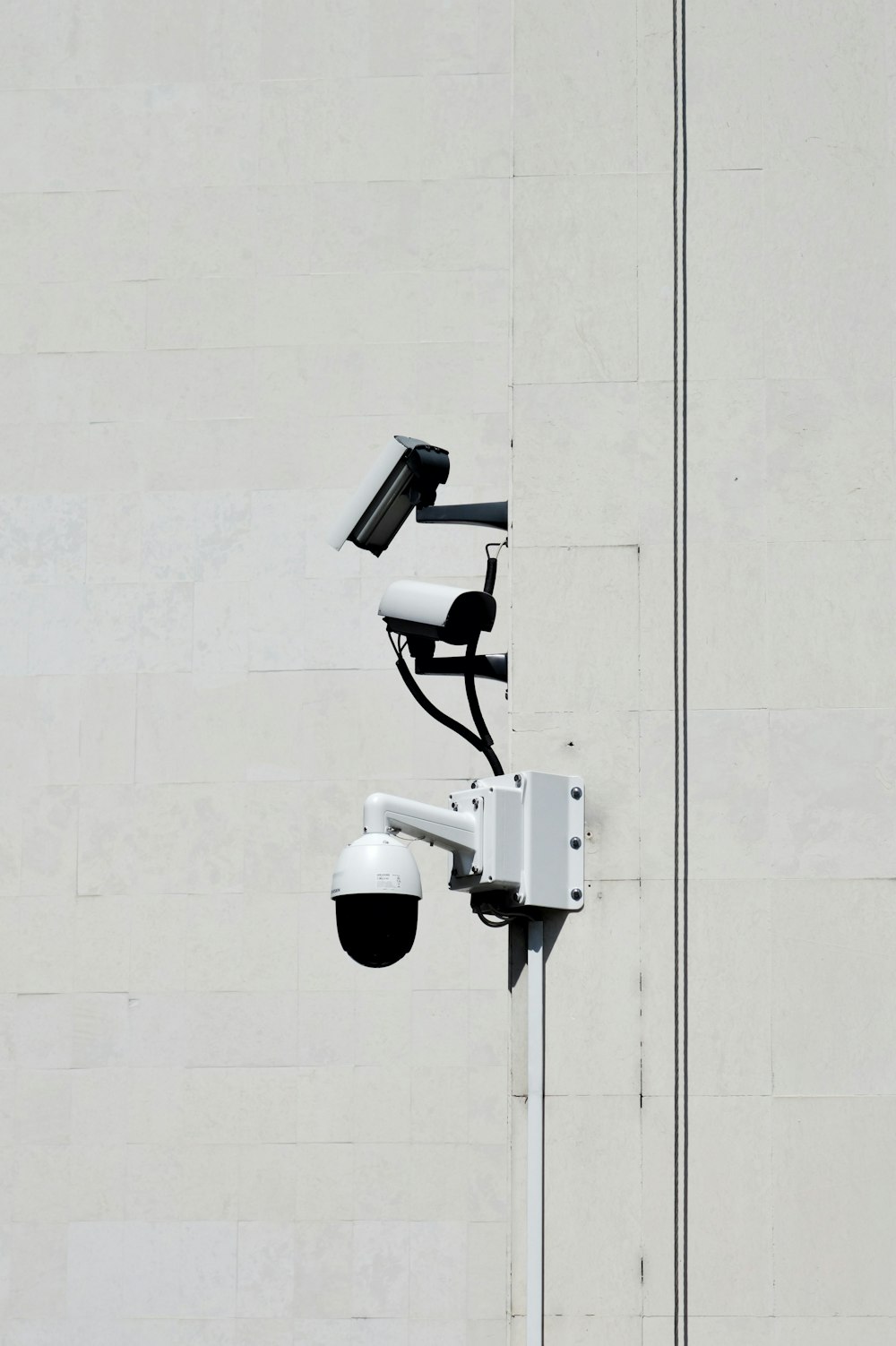 white CCTV cameras during daytime
