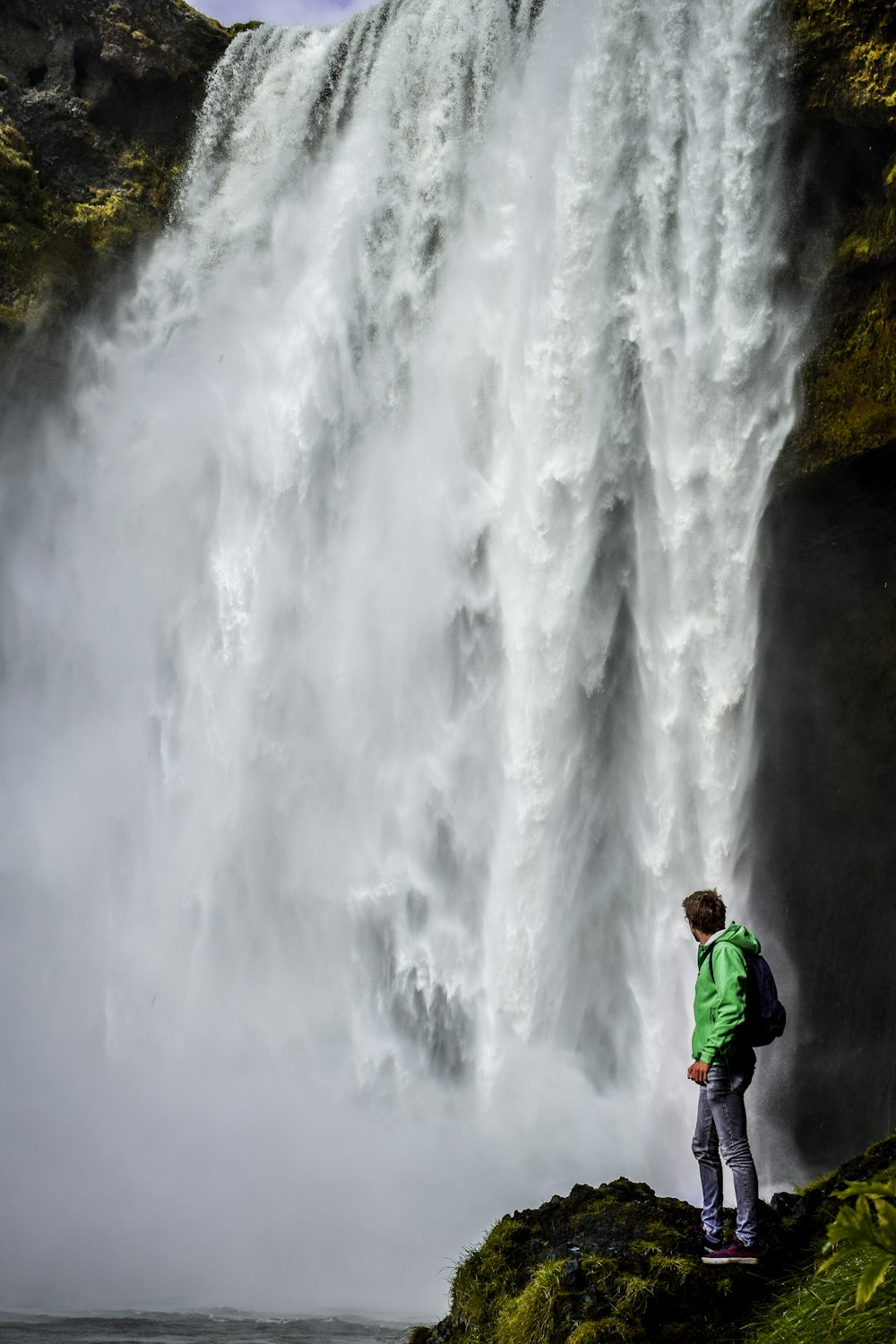 person looking at waterfalls