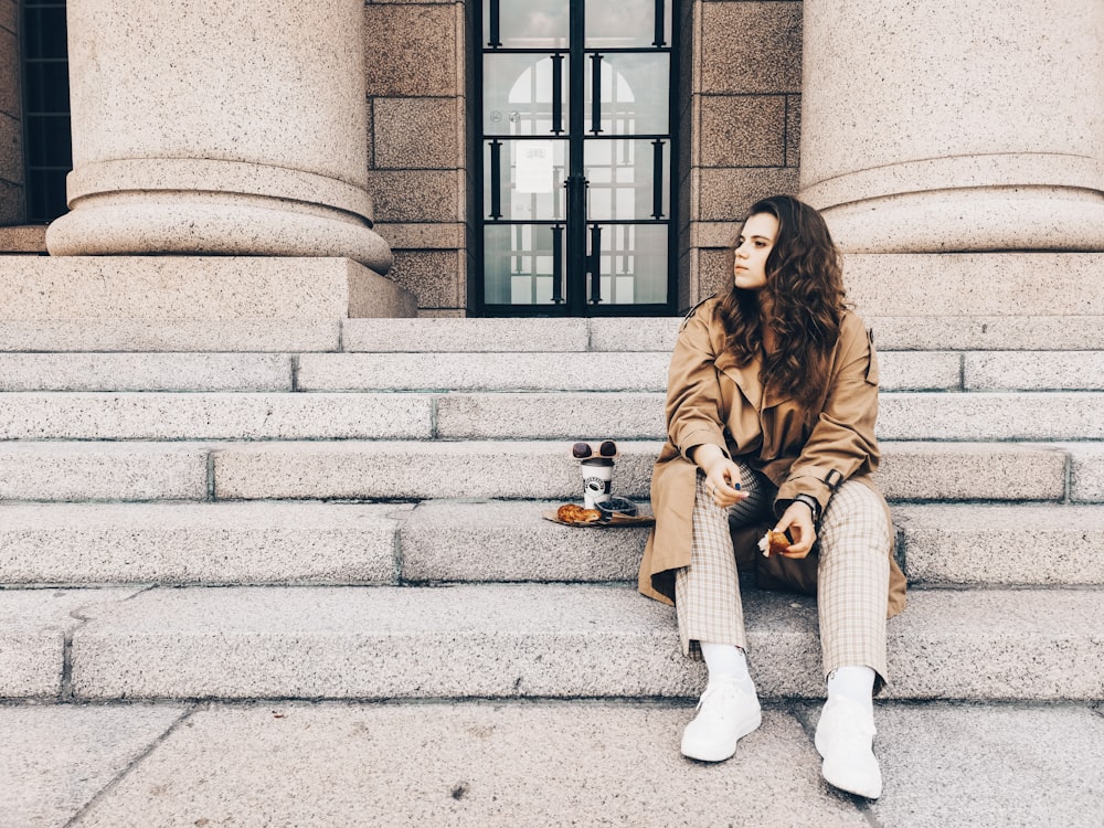 woman sitting on concrete stair