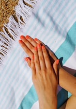 person's hands putting on towel