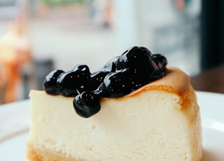 sliced cake with berries on top