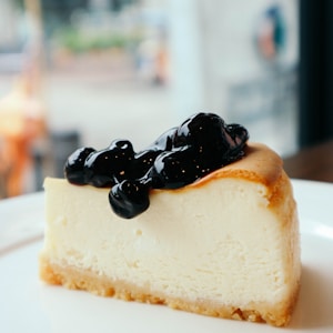 sliced cake with berries on top