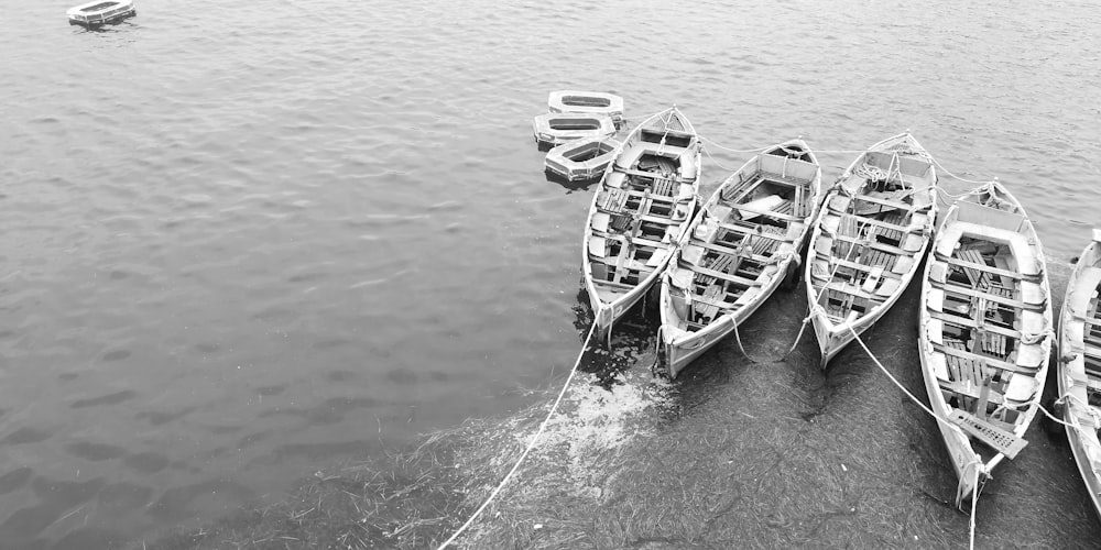 grayscale photography of boats in body of water