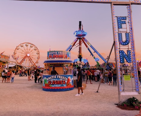 A colorful cotton candy and slush machine setup at a lively outdoor party.
