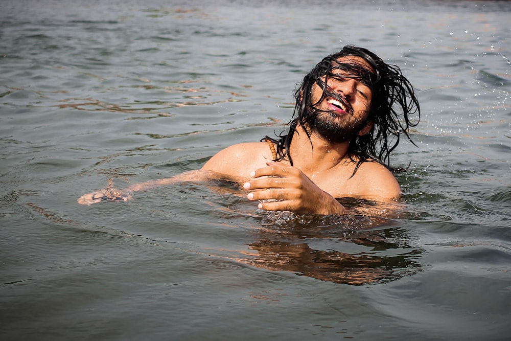 a man in the water with a frisbee in his hand