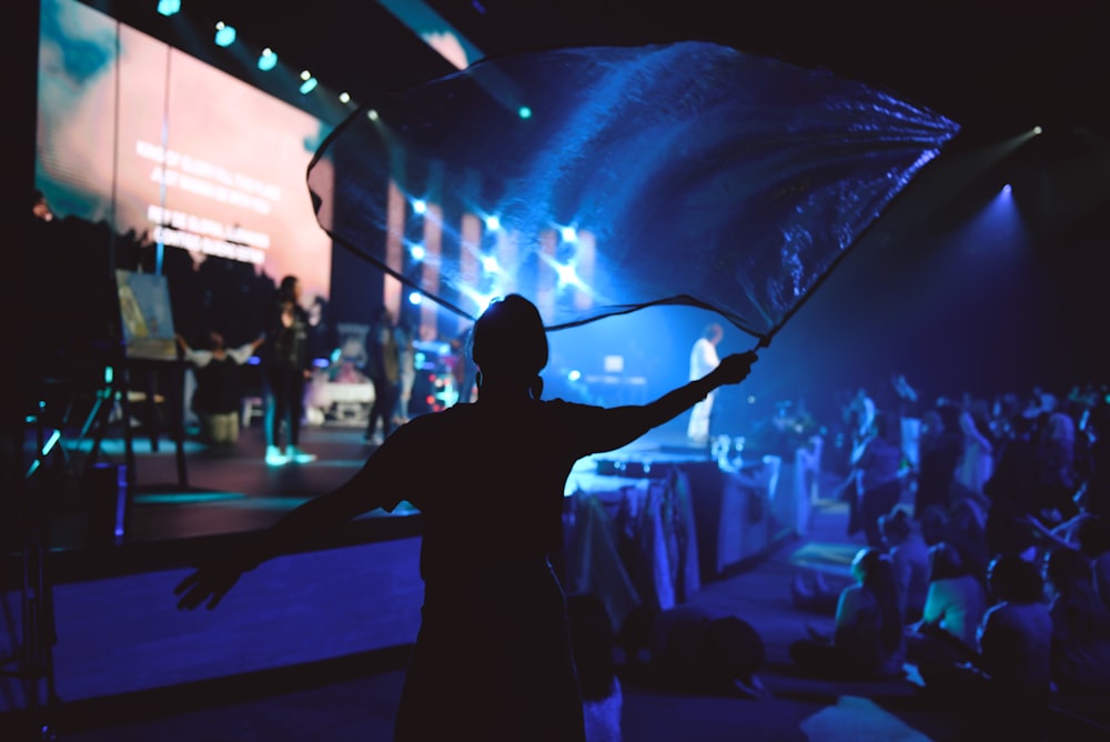 man raising blue flag