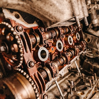 selective focus photography of gray and brass-colored metal parts