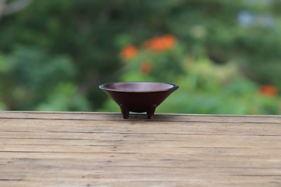 round brown bowl on wooden surface samoa google meet background