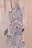 A hand adorned with intricate henna designs featuring floral and paisley motifs. The design is detailed with curved lines and dot accents, creating an elegant and artistic look.
