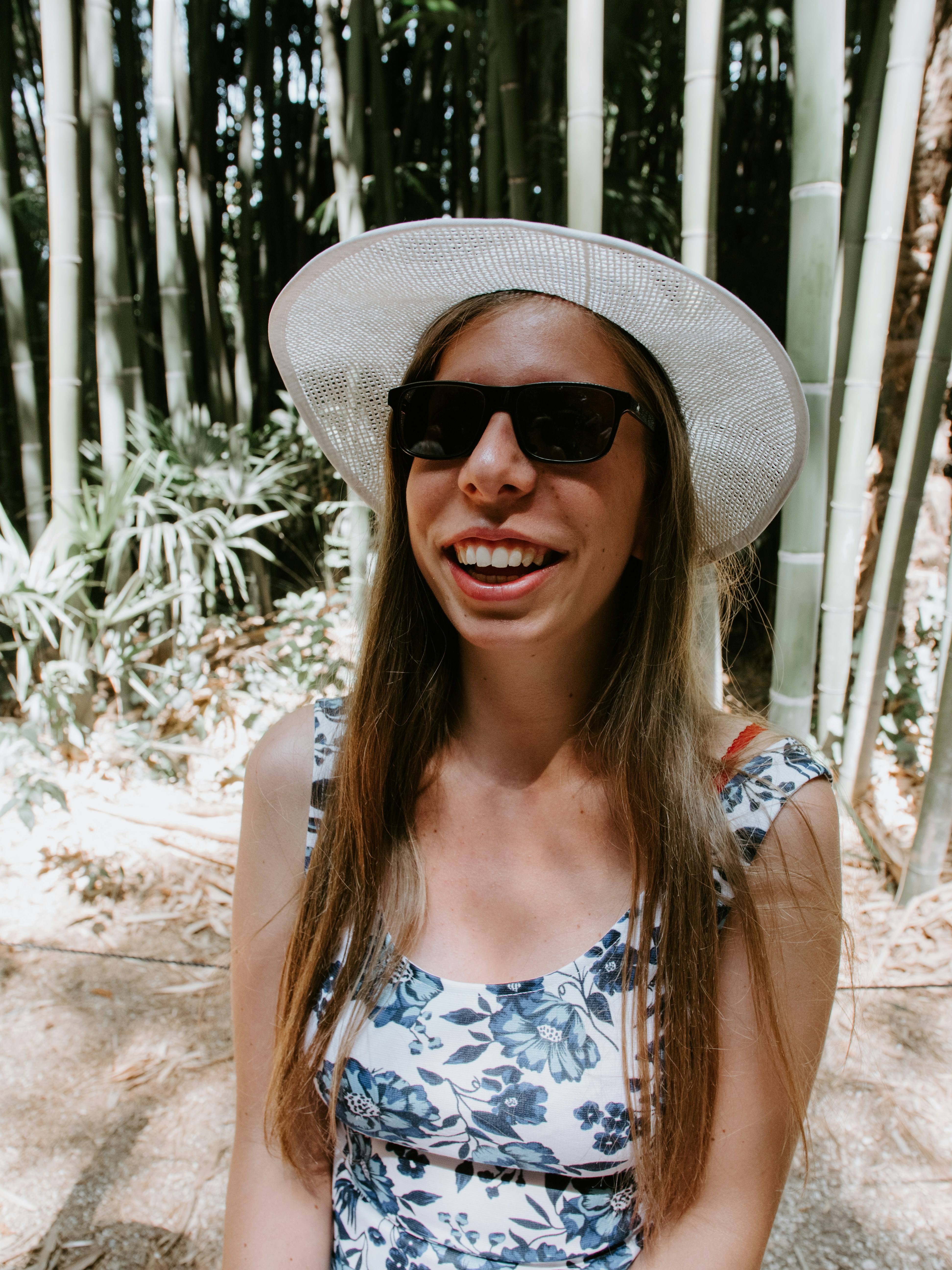 Woman wearing blue and white floral tank top photo Free Clothing