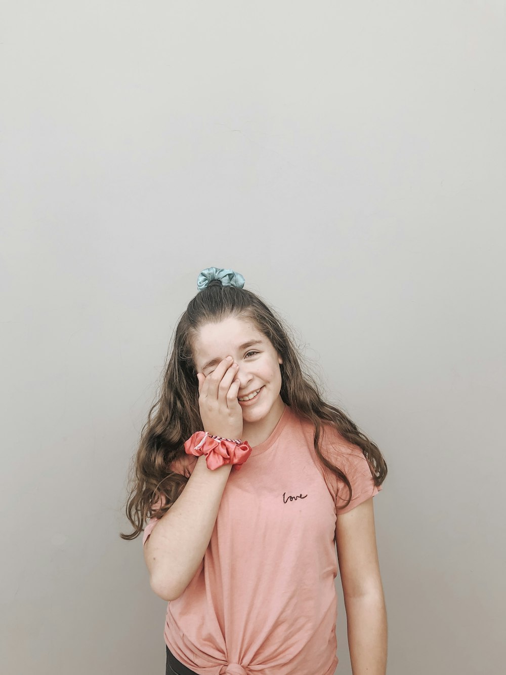 smiling girl wearing pink sleeveless top