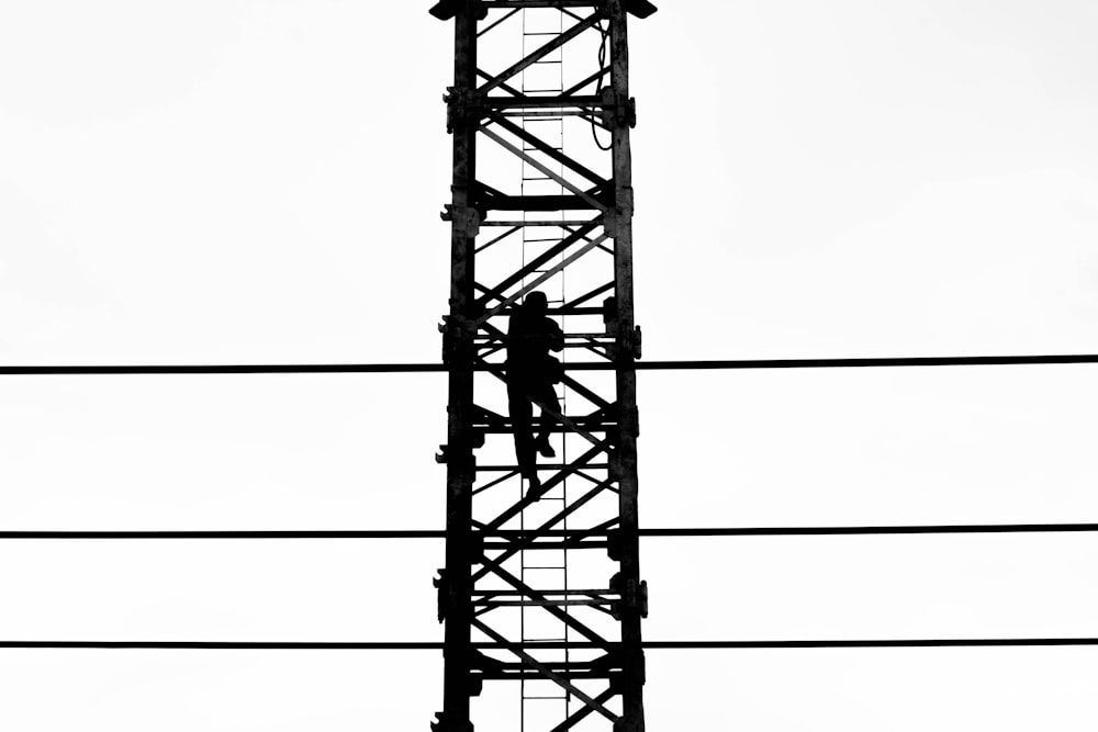 person climbing on tower illustration